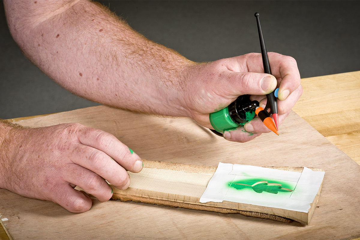 Airbrushing a leaf stencil