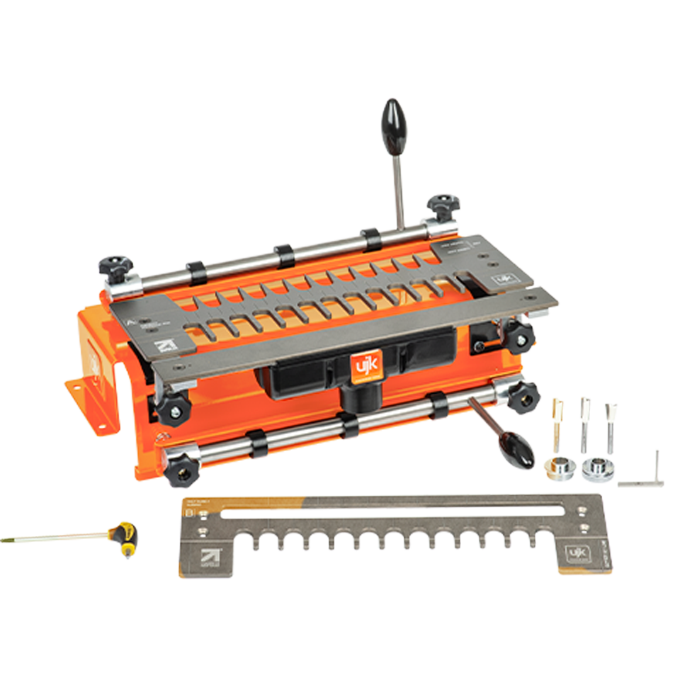 An orange and grey dovetial jig, shown with a metal measuring gauge, adjustment screws, and a spirit level on a white background.