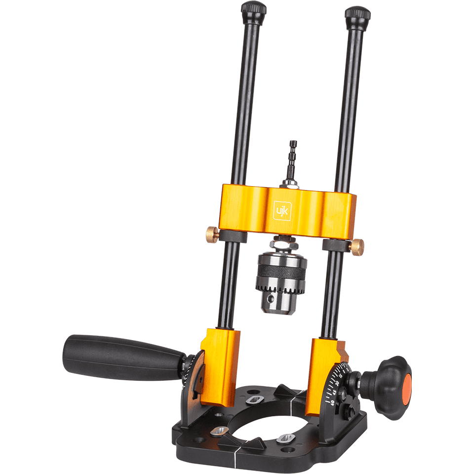 A heavy-duty metal drill guide with a bright orange and black anodized finish, featuring a black handle, adjustable vertical columns, and a central chuck.