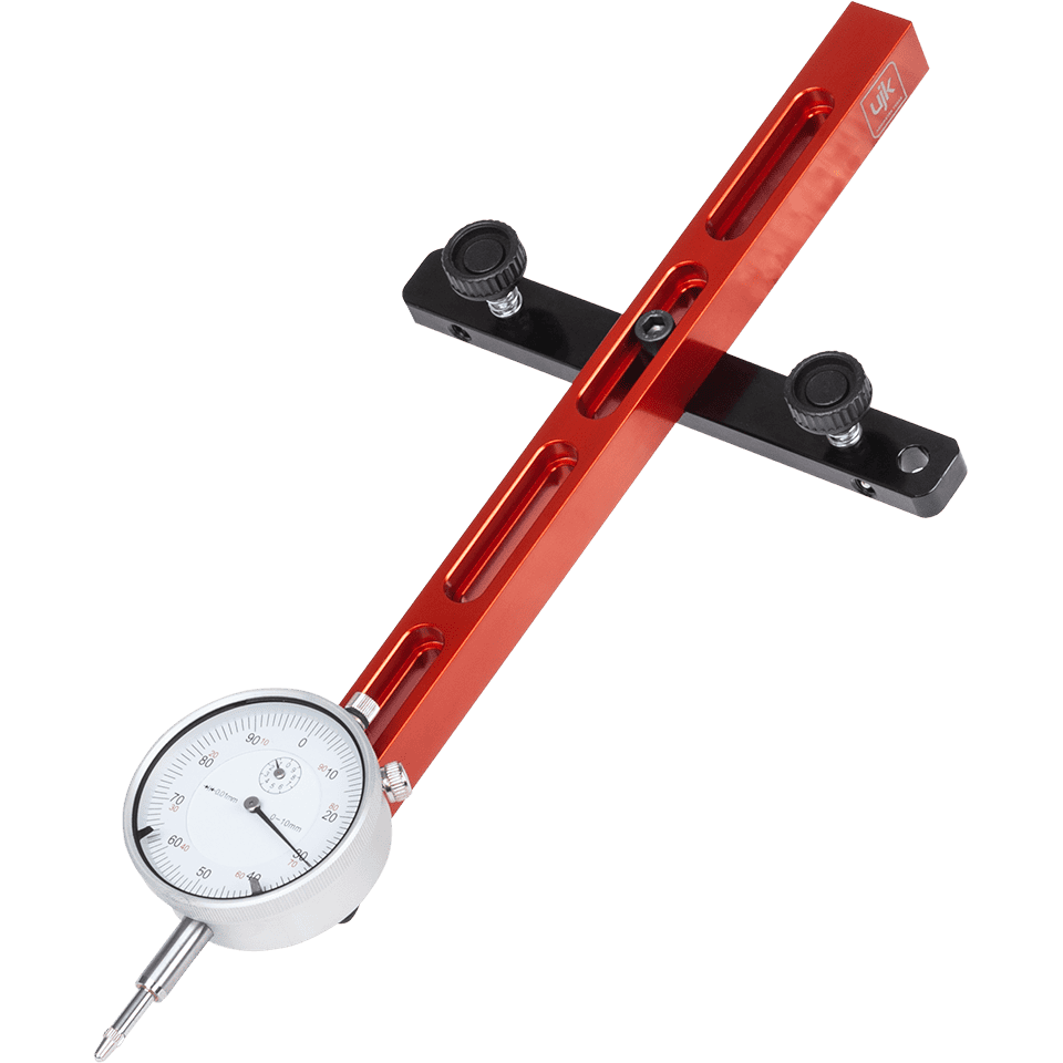 A precision measurement tool with a bright orange anodized aluminum body, a black adjustment bracket with two black thumbscrews, and a silver dial face with a white background.