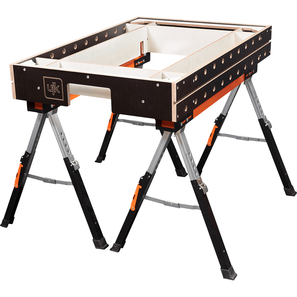A JUK brand workbench with a black and white frame, orange accents, and folding silver and black legs, shown on a plain white background.
