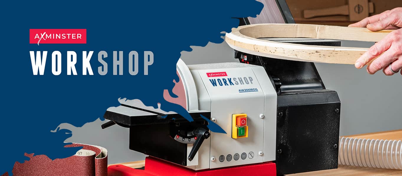 A workshop machine branded AXMISTER WORKSHOP, shown in use with a person's hands holding a circular wooden template over the machine. The scene has a blue graphic background with the AXMISTER WORKSHOP logo and a sanding belt visible in the lower left.