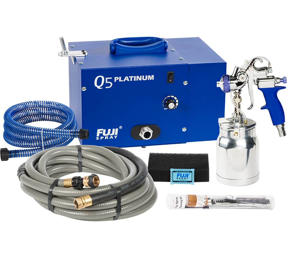 Fuji Spray Q5 Platinum spray gun kit with a blue power unit, blue and grey hoses, a silver spray gun, a metal paint can, a black sponge block, and accessories on a white background.