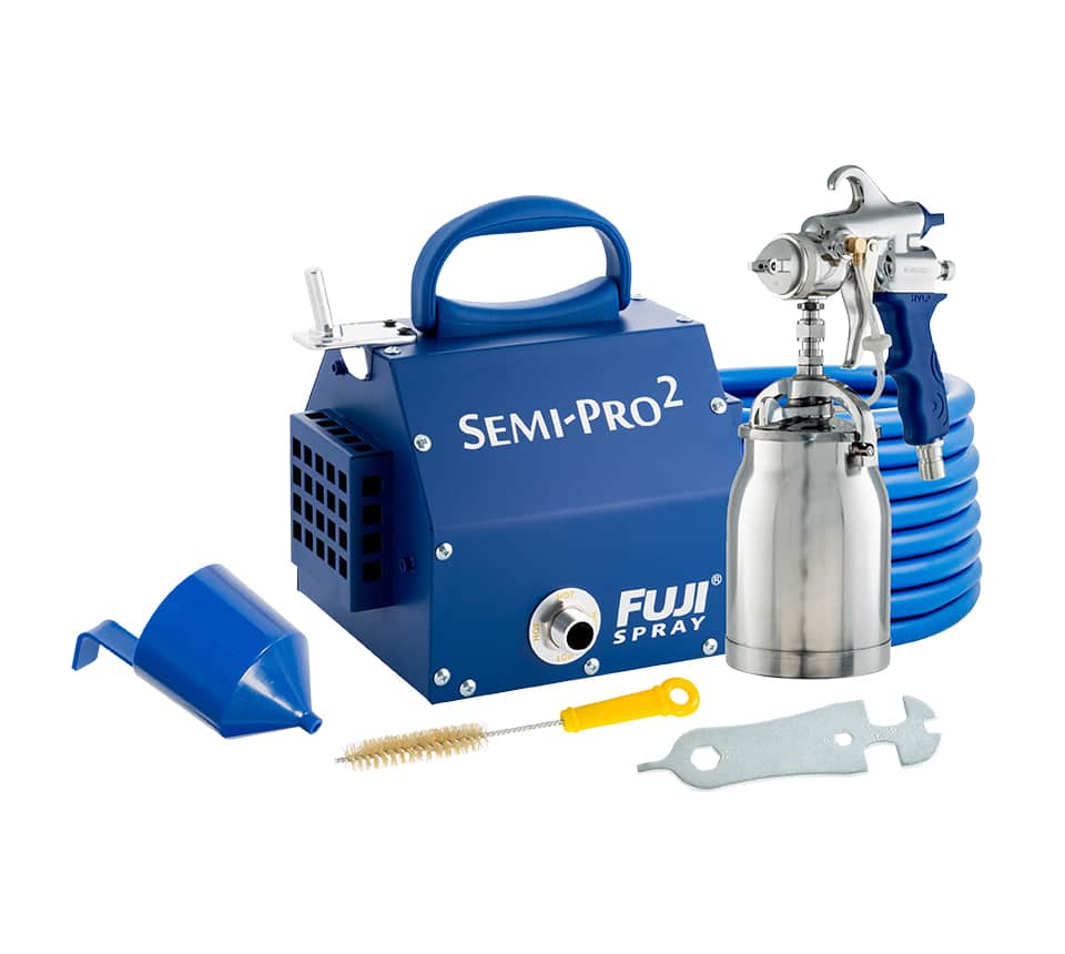 Fuji Semi-Pro 2 paint spray kit with a blue portable air compressor, silver spray gun, blue hose, blue funnel, brush, and metal wrench on a white background.