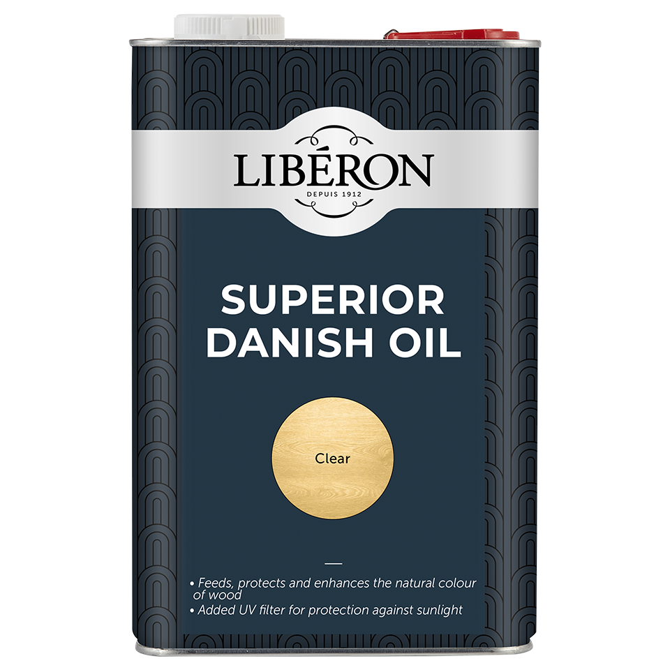 A metal can of Liberon Superior Danish Oil in the Clear finish, featuring a dark navy blue and black patterned design with a white brand label and a gold circle indicating the finish.