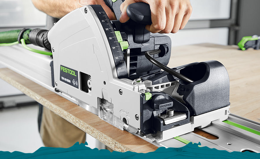 A person operating a Festool  saw on a wooden workbench, with the white, black, and green tool prominently shown in a workshop setting.