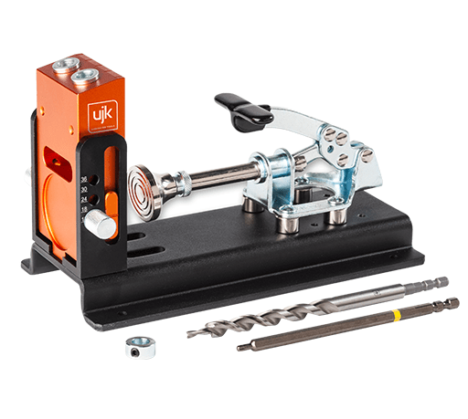 A UJK pocket hole jig with an orange and black clamp mechanism, a black base, a metal lever, and two metal drill bits on a white background.